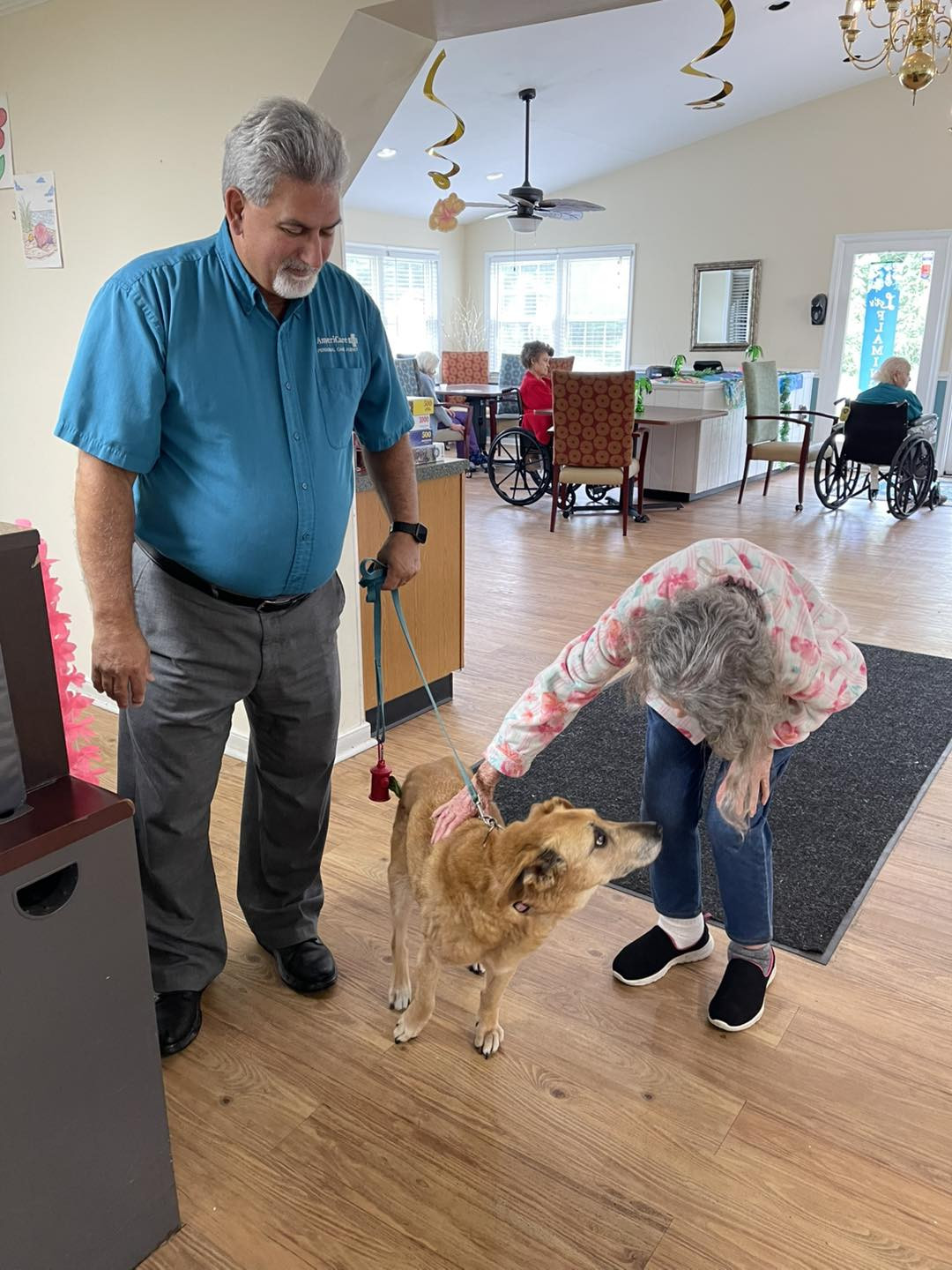 VP Operations Bill Hurt and 19-Year-Old Therapy Dog River visiting residents at EH Bloom Retirement Center