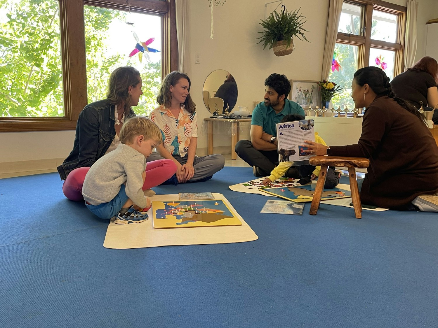 A Lead Guide connects with their classroom community at Parent Day, where children show their work to parents. 