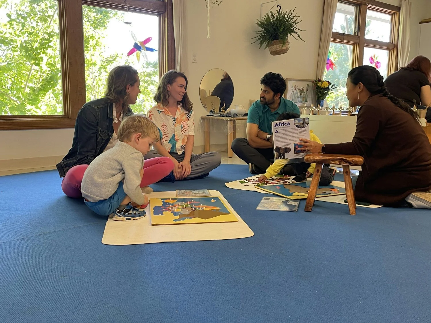 A Lead Guide connects with their classroom community at Parent Day, where children show their work to parents. 
