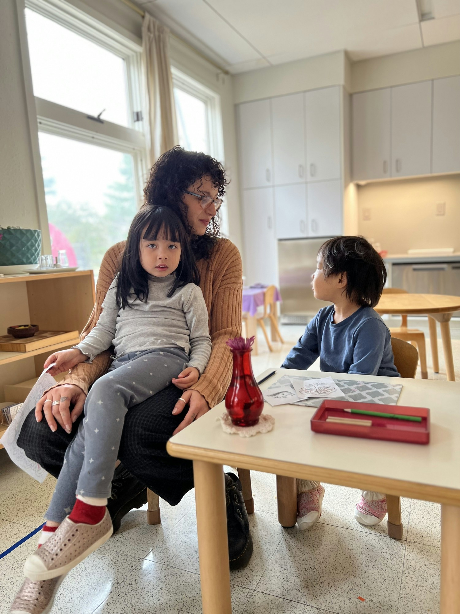 An Assistant Guide shares a quiet moment in a Primary classroom. 