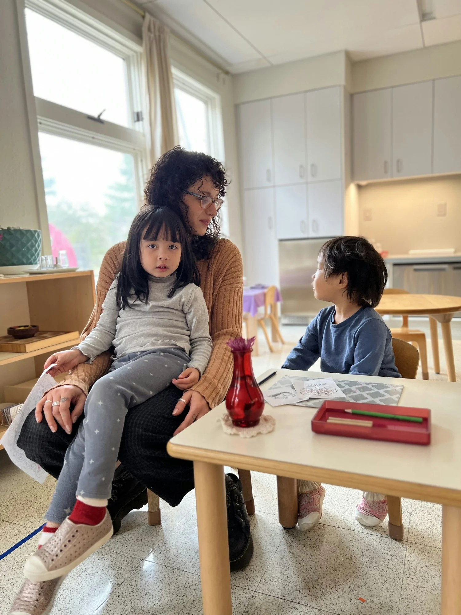 An Assistant Guide shares a quiet moment in a Primary classroom. 