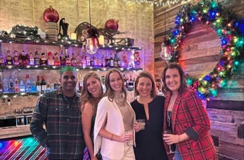 JustFab Co-CEO Shauna Drumright (second from right) celebrating with the team at an annual holiday party