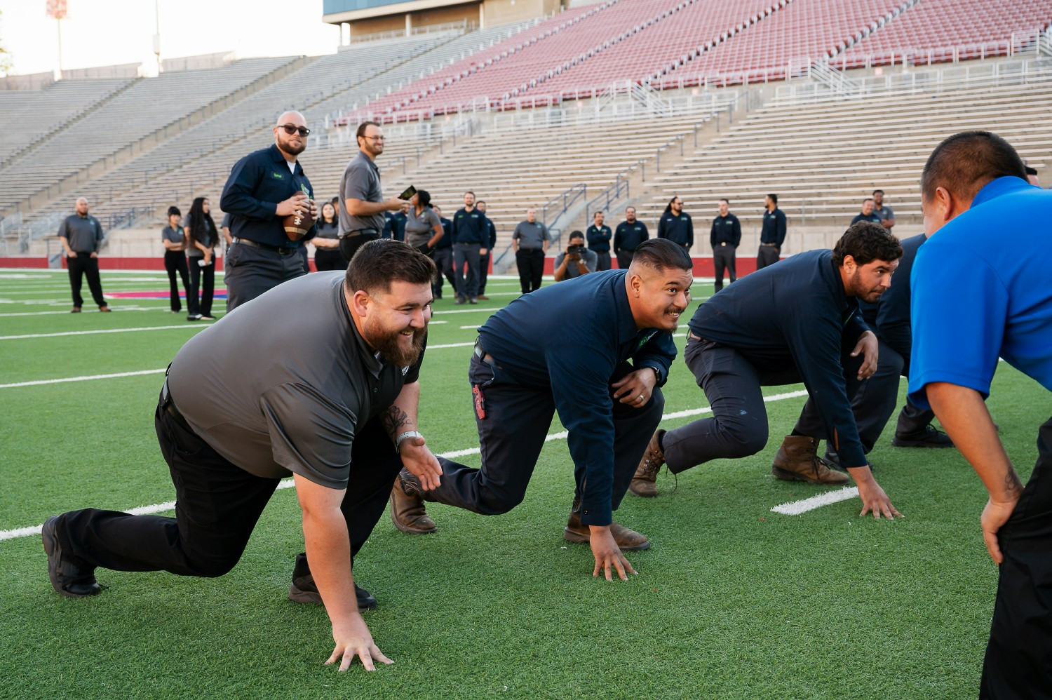 Balanced Comfort team having some fun out on the Fresno State football field.