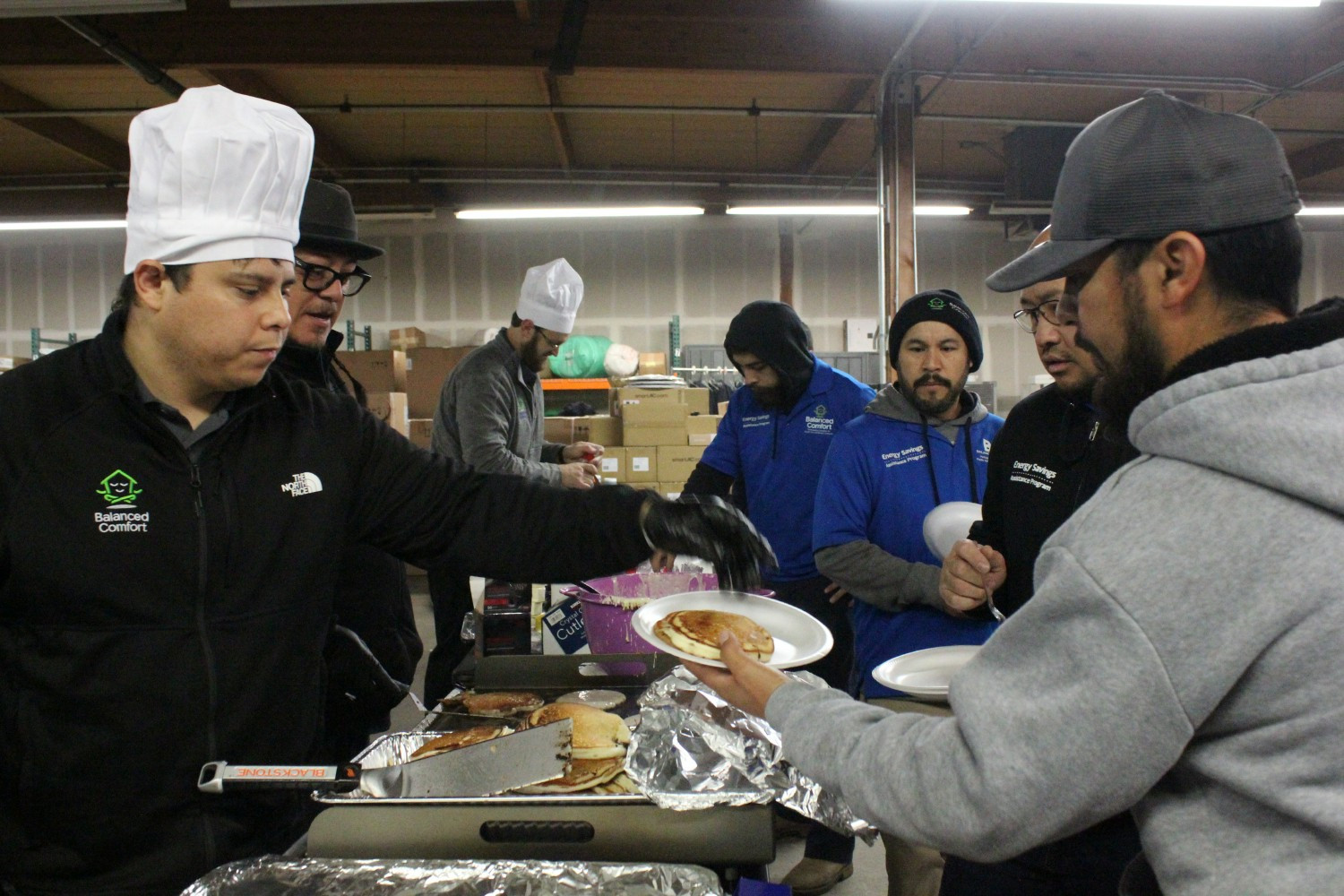 Managers and supervisors making breakfast for the team. 