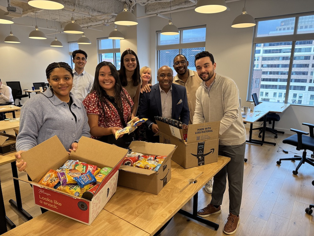 Assembling care packages for our troops after a company meeting. Living our values of generosity and kindness. 