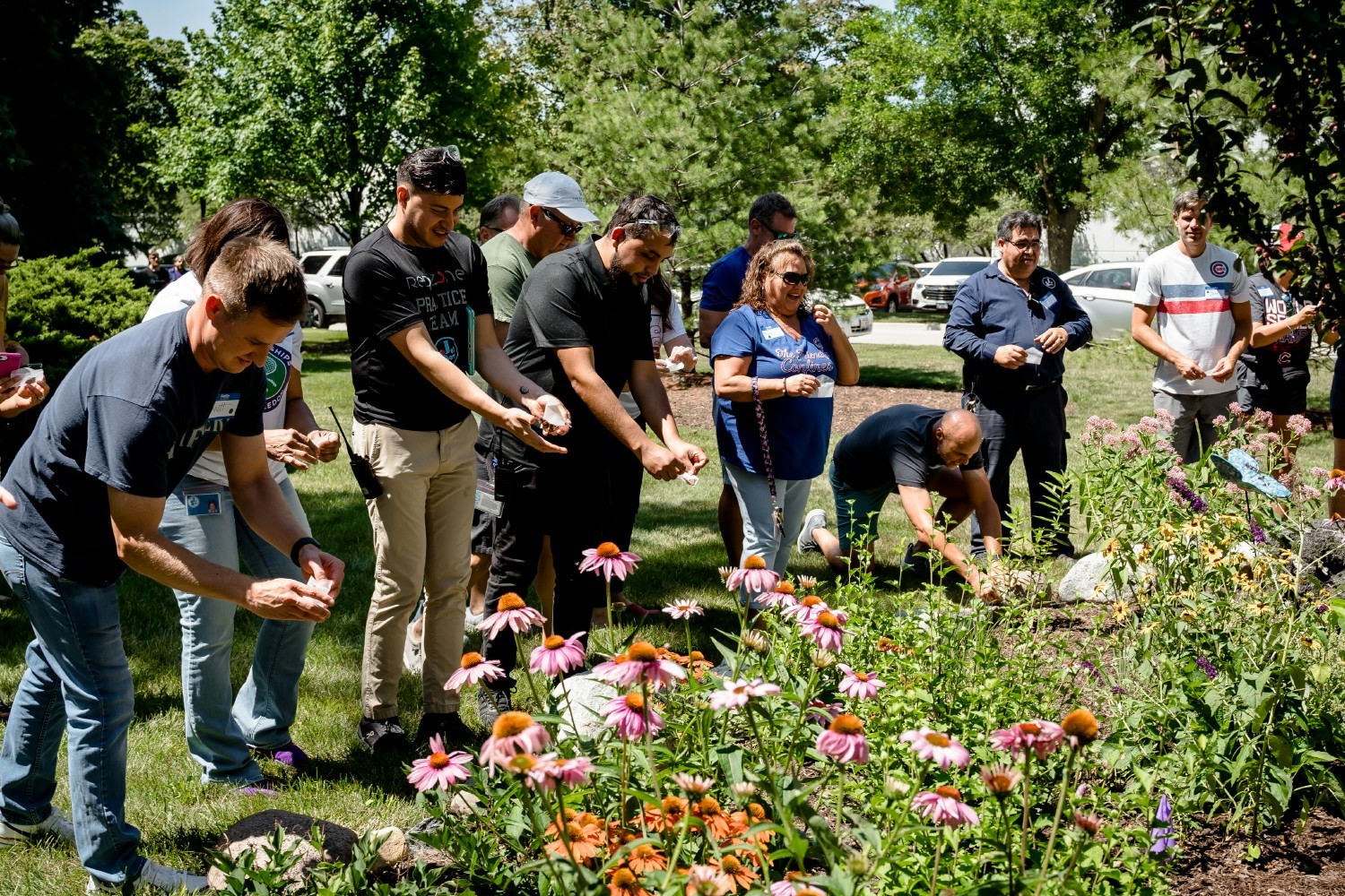 Employees gather around Jel Sert's garden to release butterflies they received as a result of donating to the NOCC.
