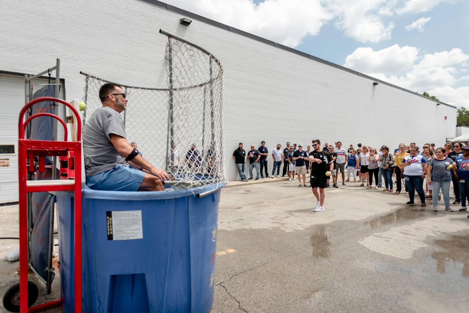 Employees gather around the dunk tank after raising money for the ACCO.  Winners dunked our Sr. Management team!