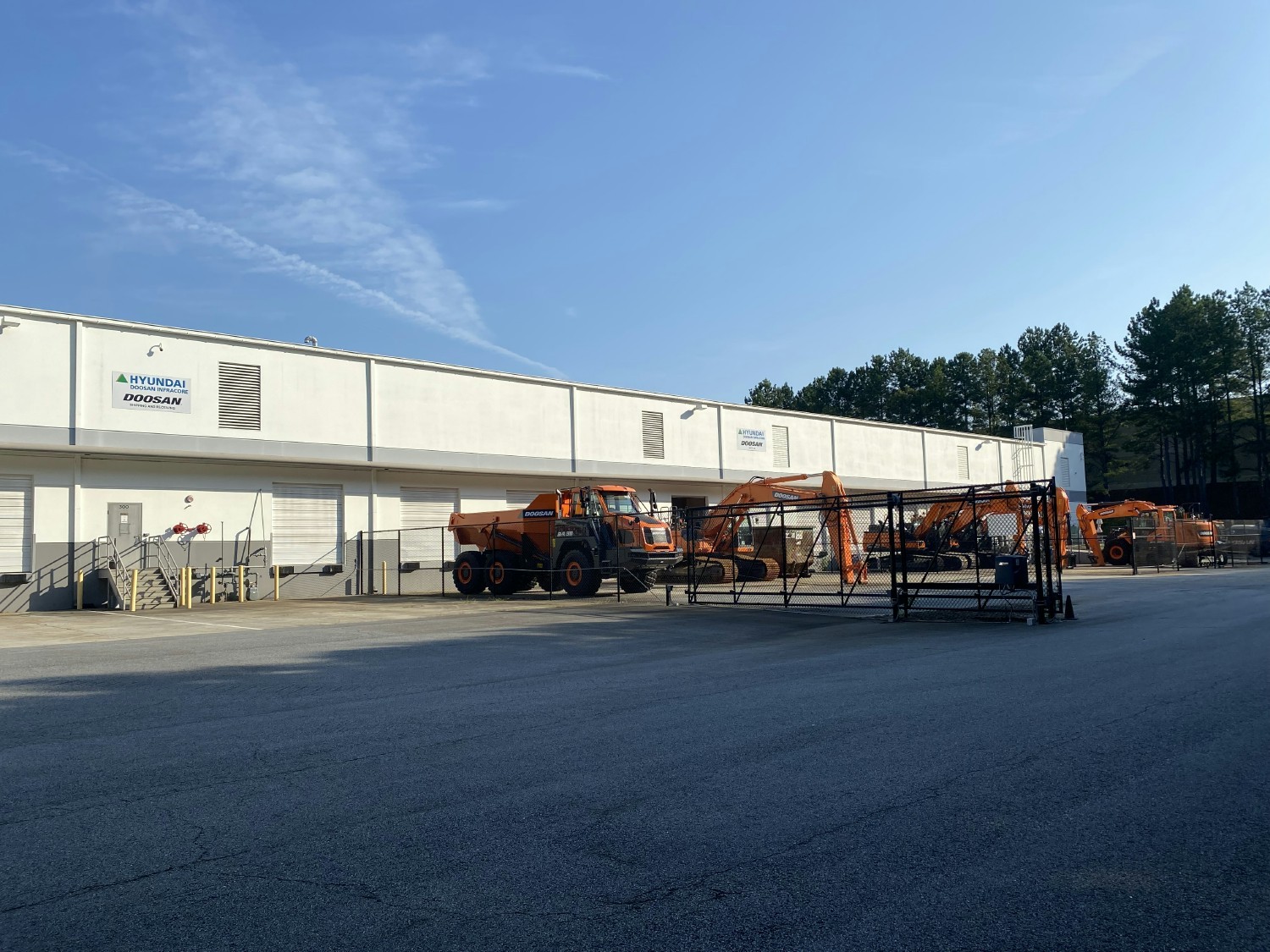 Suwanee, Georgia office - back side of the facility with parked heavy machines