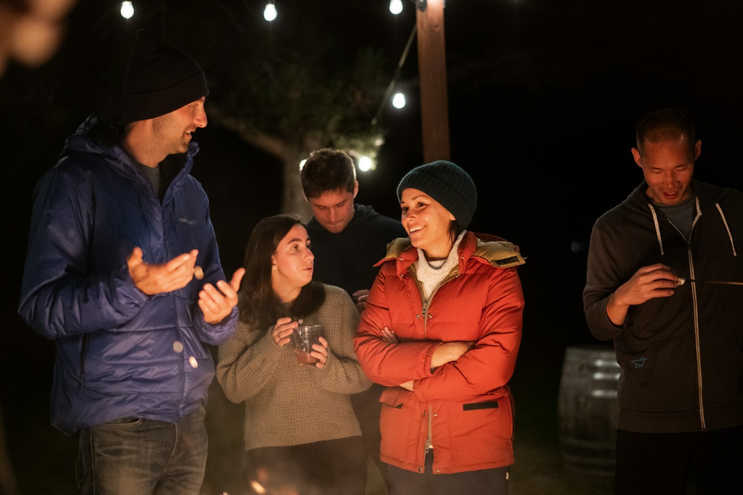 The team enjoying each other's company at a campfire