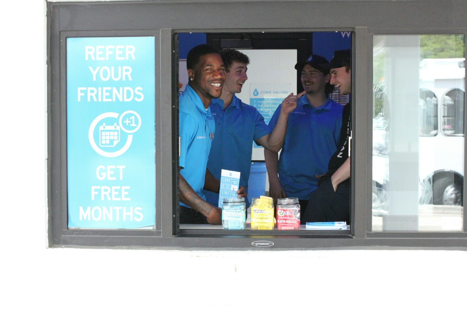 Team having fun as they greet customers pulling up to one of our clubs