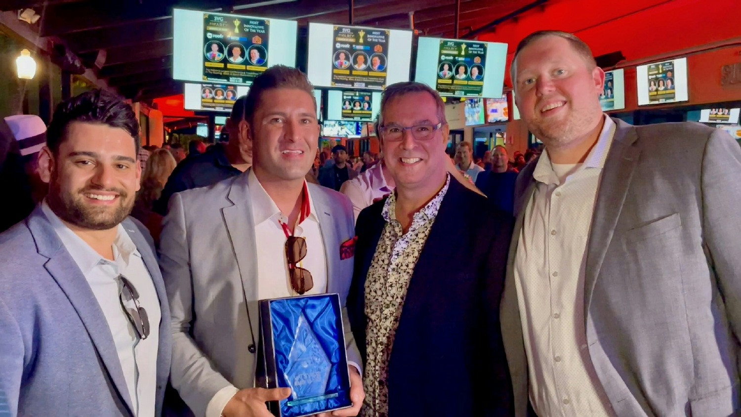 BatchService team members accept the Most Innovative Company award at the Win the Storm conference.