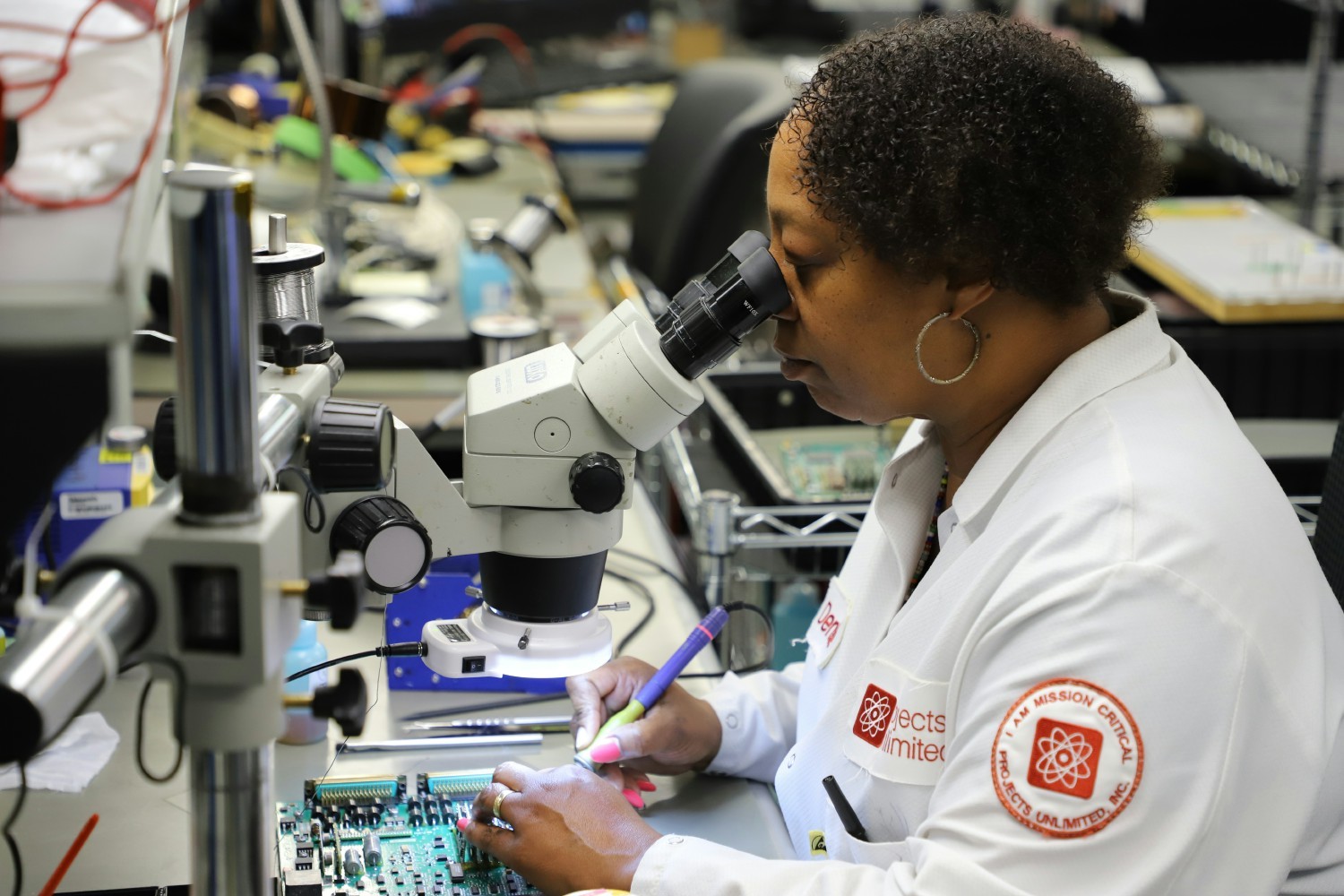 A skilled electronics assembler hard at work.