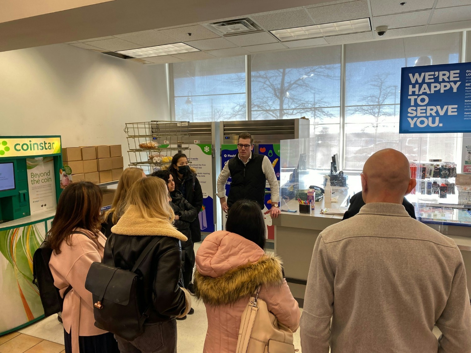 Teammates visiting Flashfood zone at grocery store.
