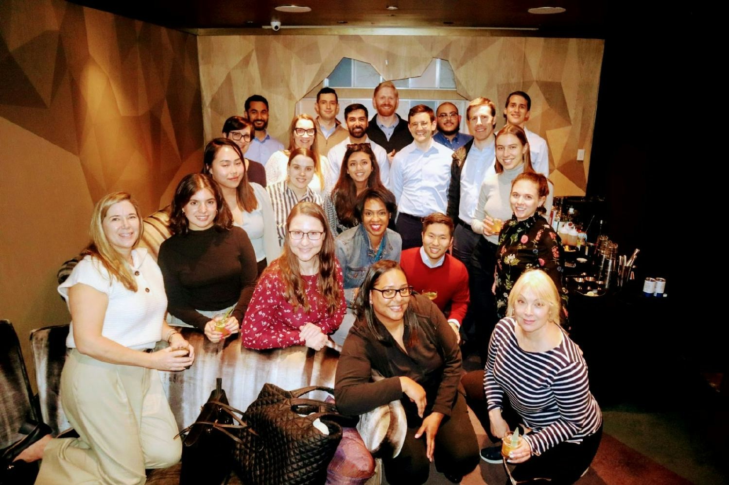 American Securities colleagues participating in a cocktail making class hosted by our 