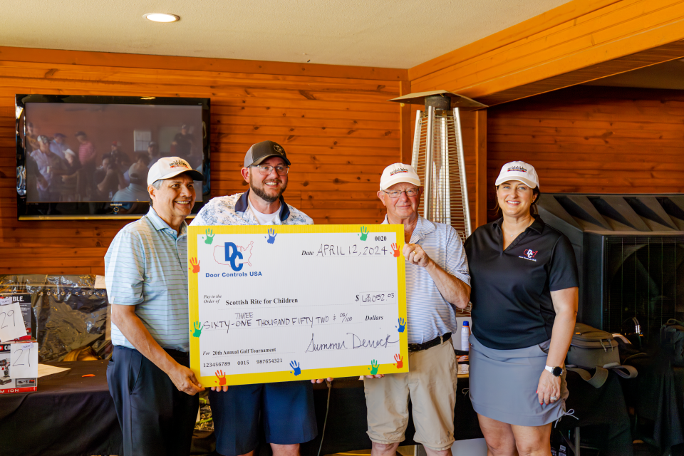 Our owners presenting a donation at our 21st annual golf tournament benefiting Texas Scottish Rite Hospital for Children