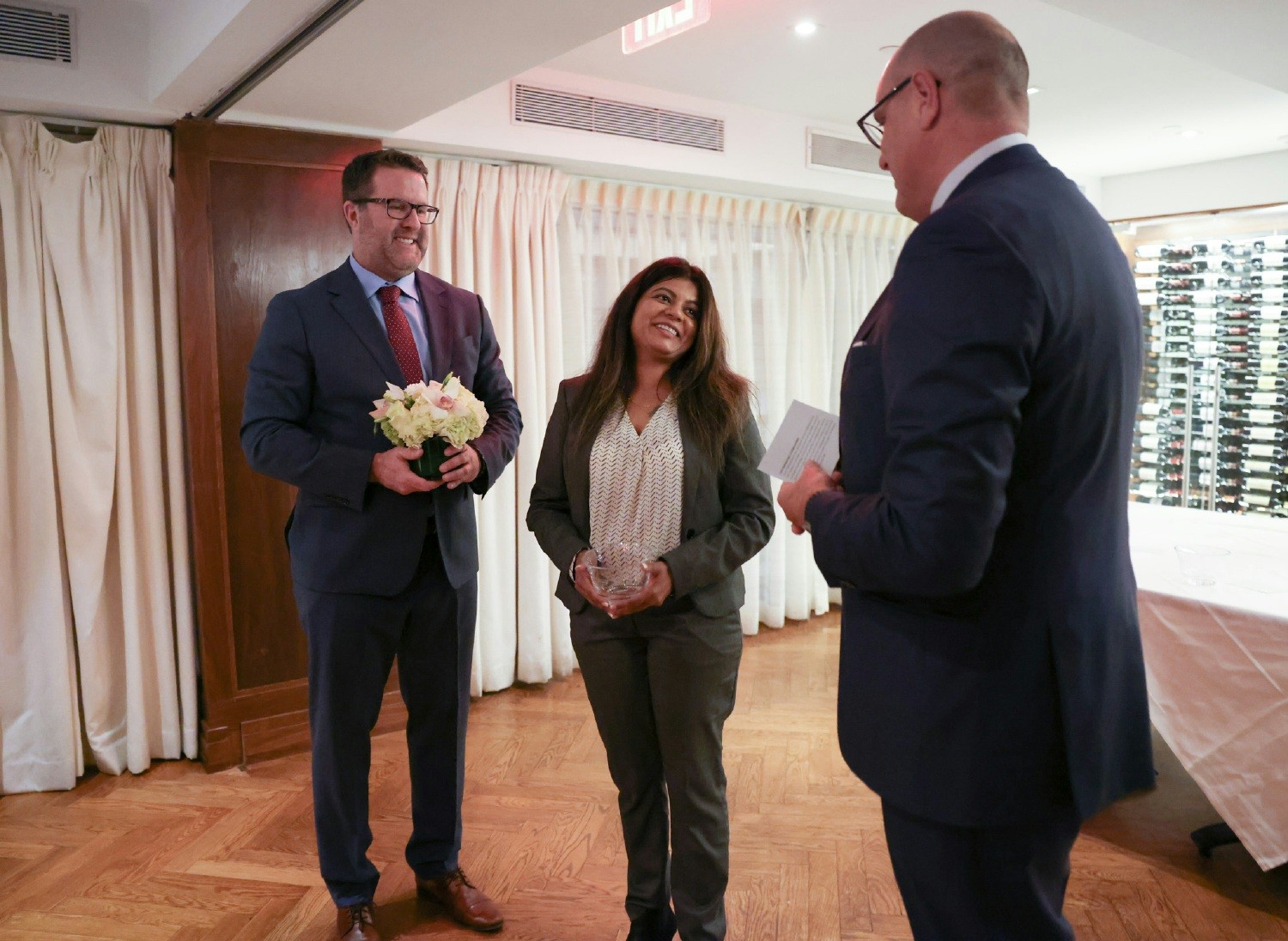An employee is presented a year-end award during a reception dinner with our CEO Oscar Villalonga and COO Lee Spurrier.