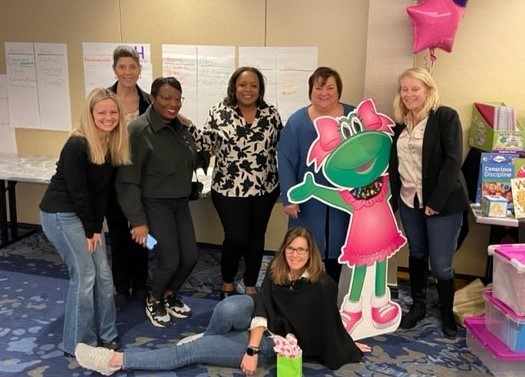 The Sales Team enjoying a photo with Miss Fanny Frog during their annual training. 