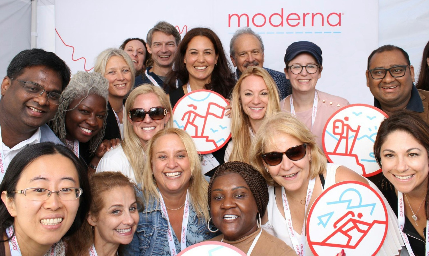 A dedicated group of Moderna colleagues come together for a moment of celebration and camaraderie at a company event