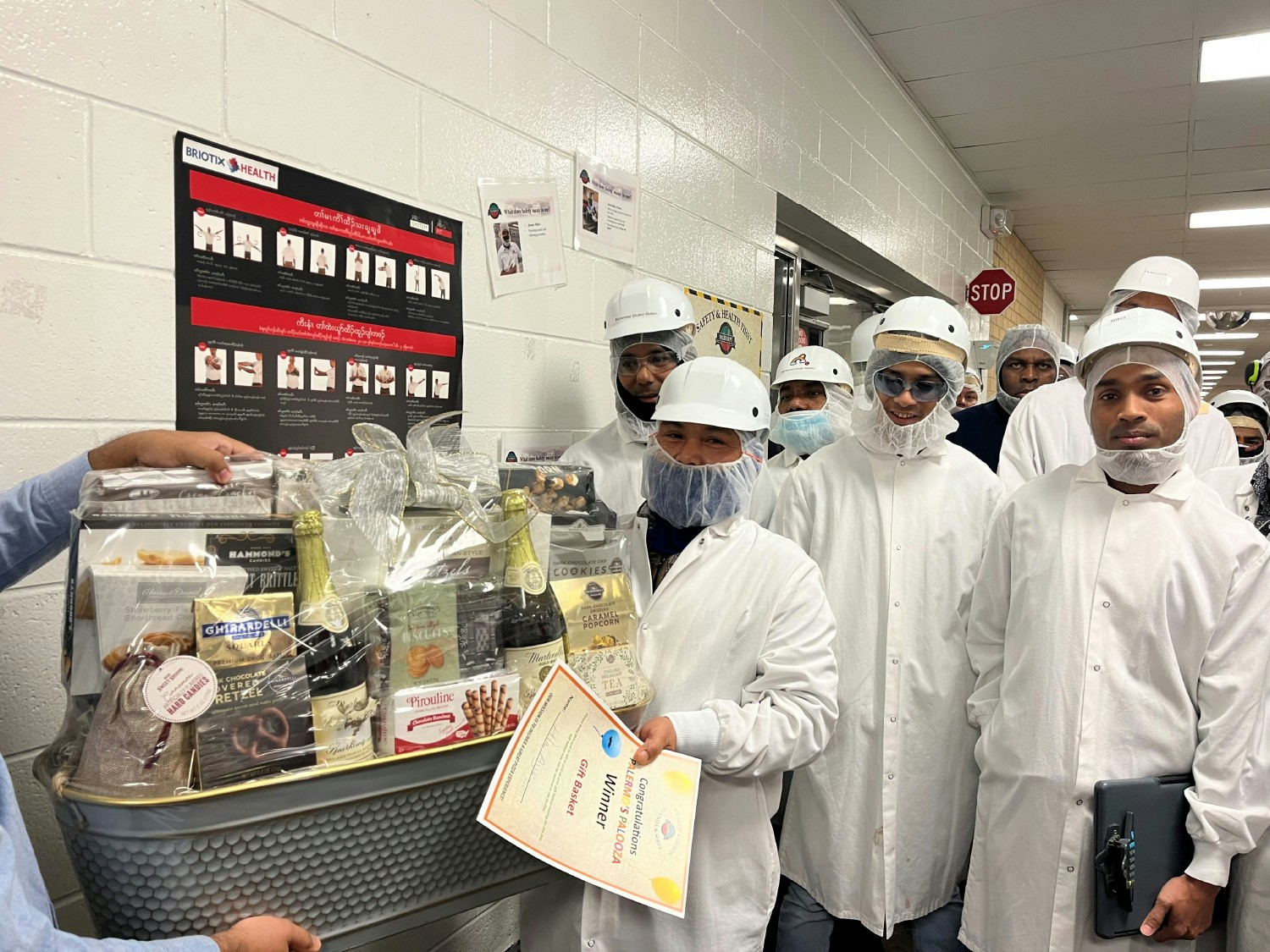 Employees celebrate one of their team members winning a luxury gift basket during Employee Appreciation Week.