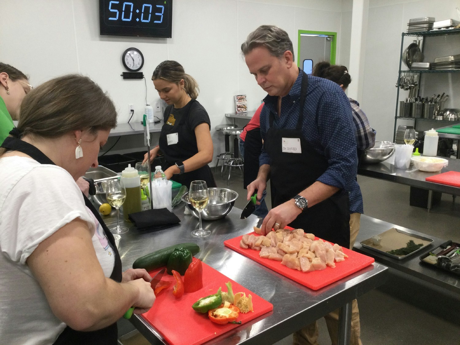Cooking to beat the clock! Team members working together in a real-life Iron Chef competition.