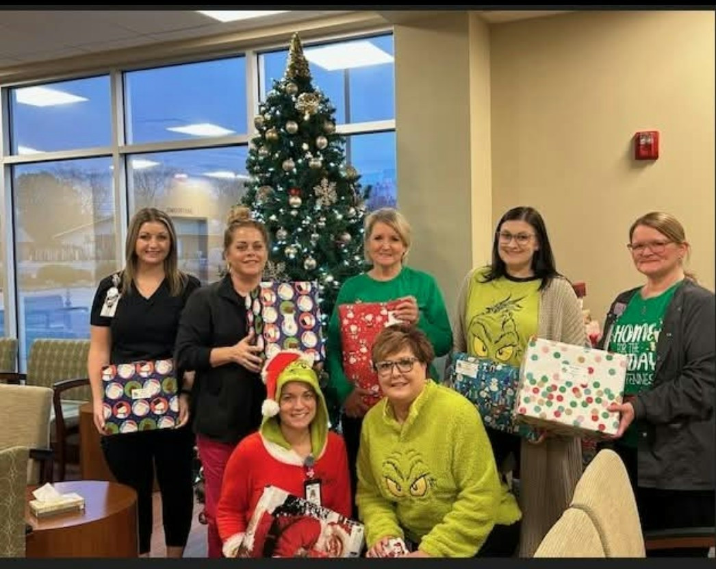 Employees proudly share their gifts for our Holiday Hugs drive, ensuring local school children stay warm this winter.