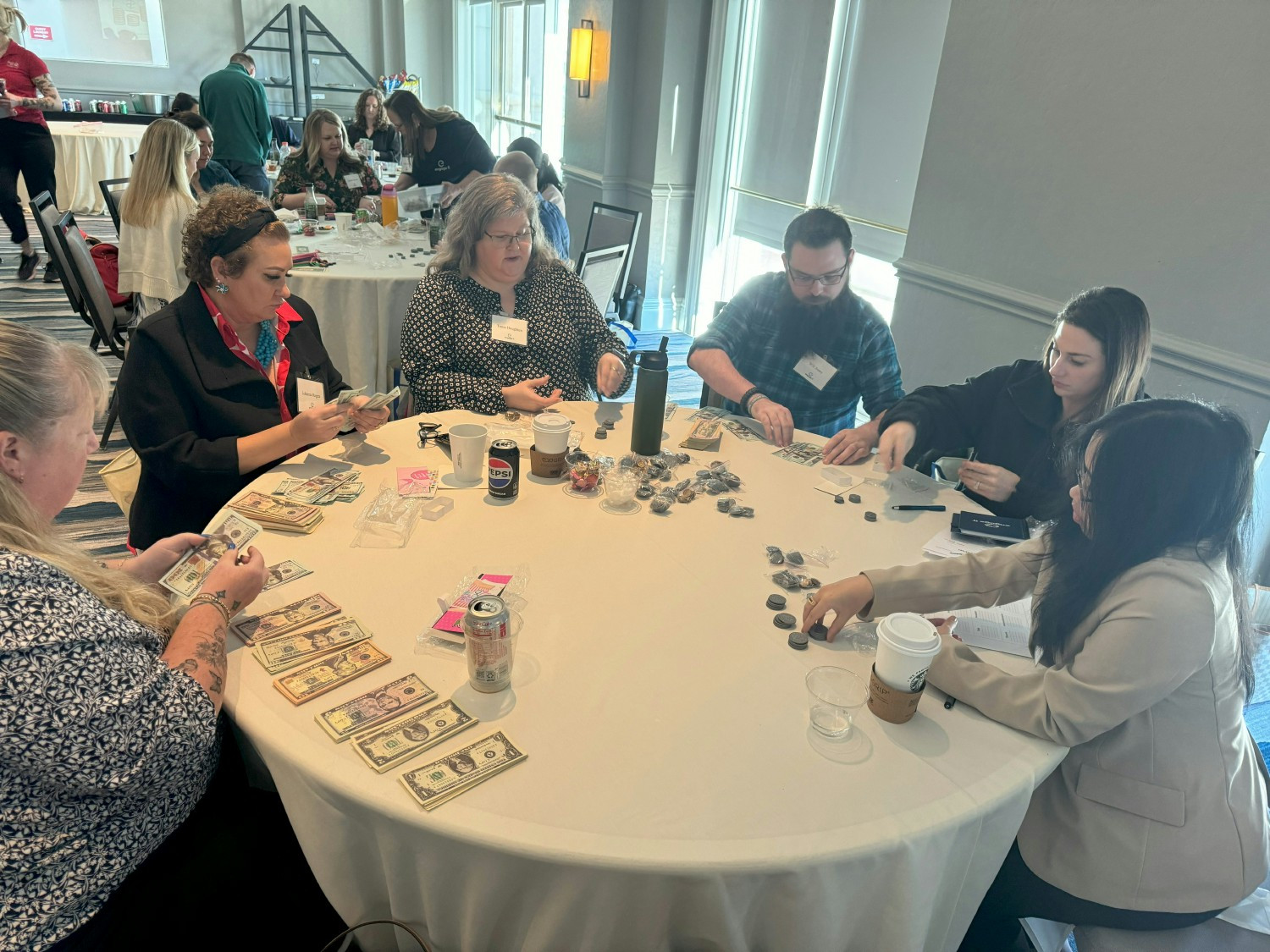 Engage fi team members work together to assemble financial empowerment kits for the United Way Suncoast. 