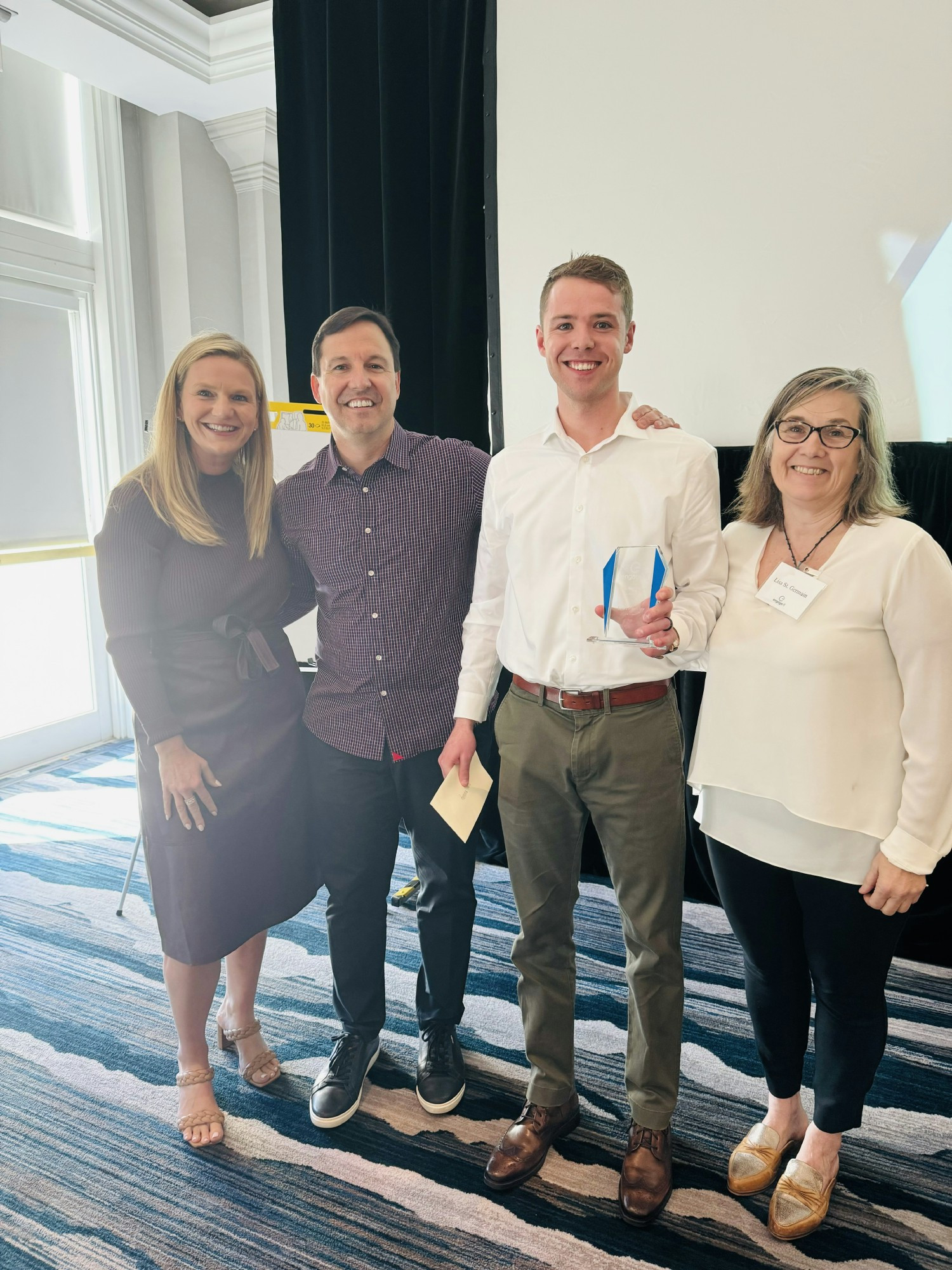 Engage fi Co-Founder & CEO, President/COO, and VP of Product Development present an employee recognition award.