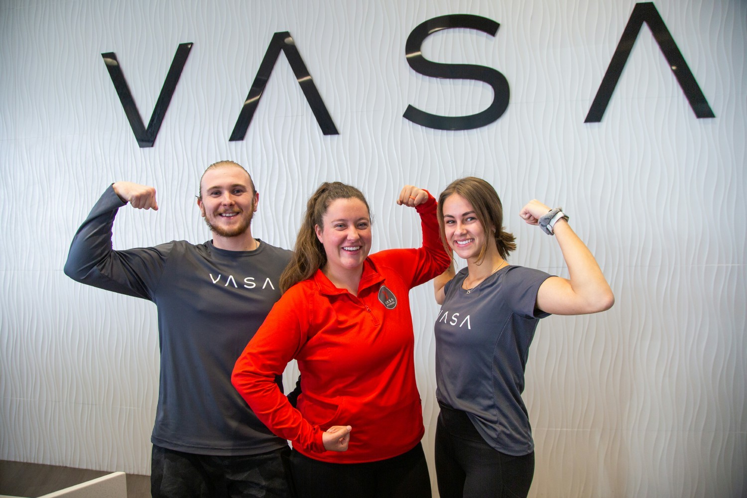 Team members at VASA’s front desk show off their muscles—and smiles—for the camera.