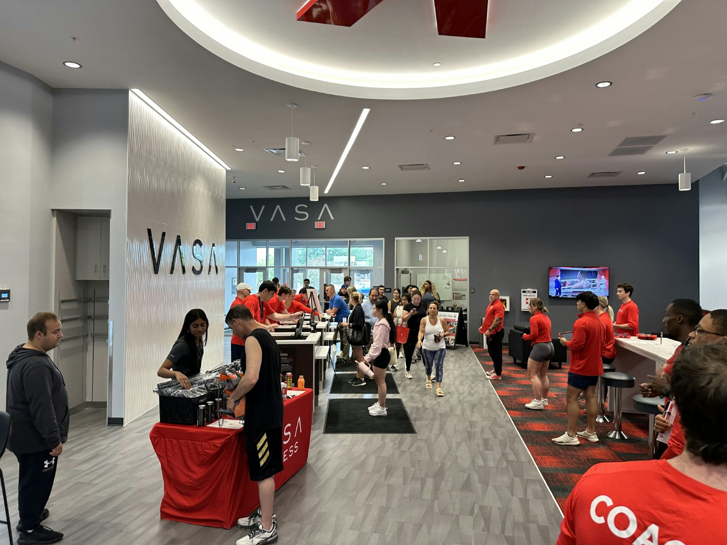 Team members come together to help and celebrate the grand opening of a new club.