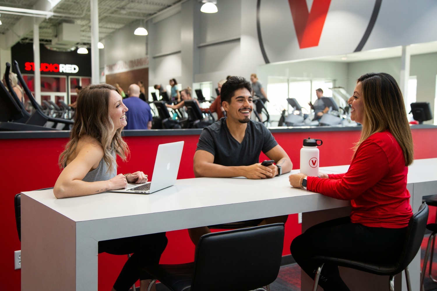 Team members enjoy socializing at one of VASA’s community tables, located near the entrance of the club.
