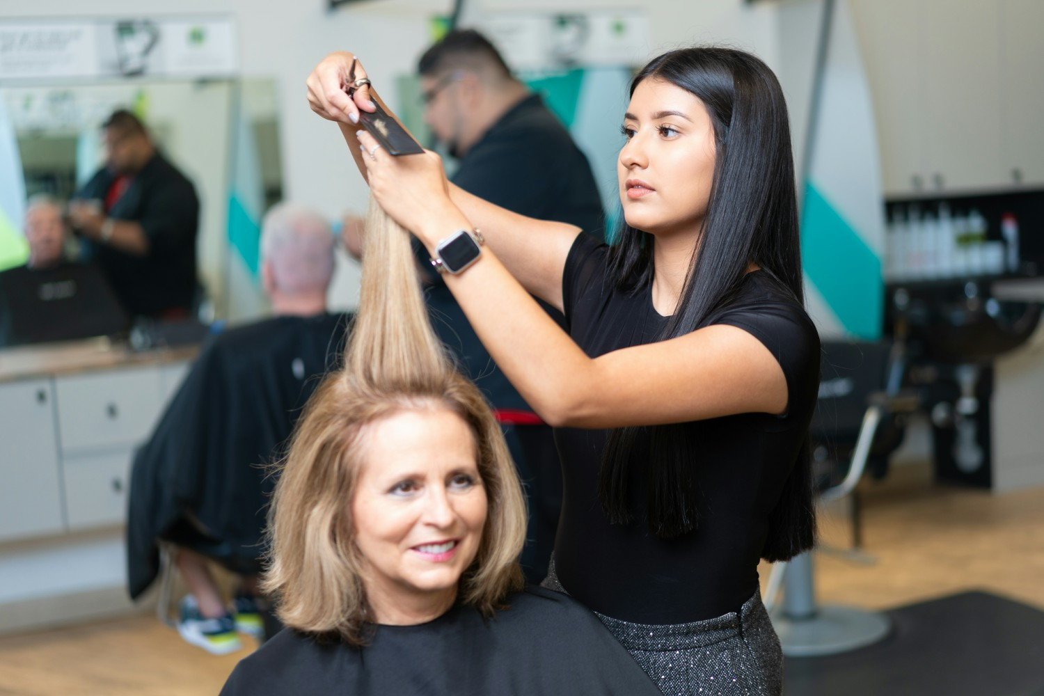 Stylist cutting woman's hair