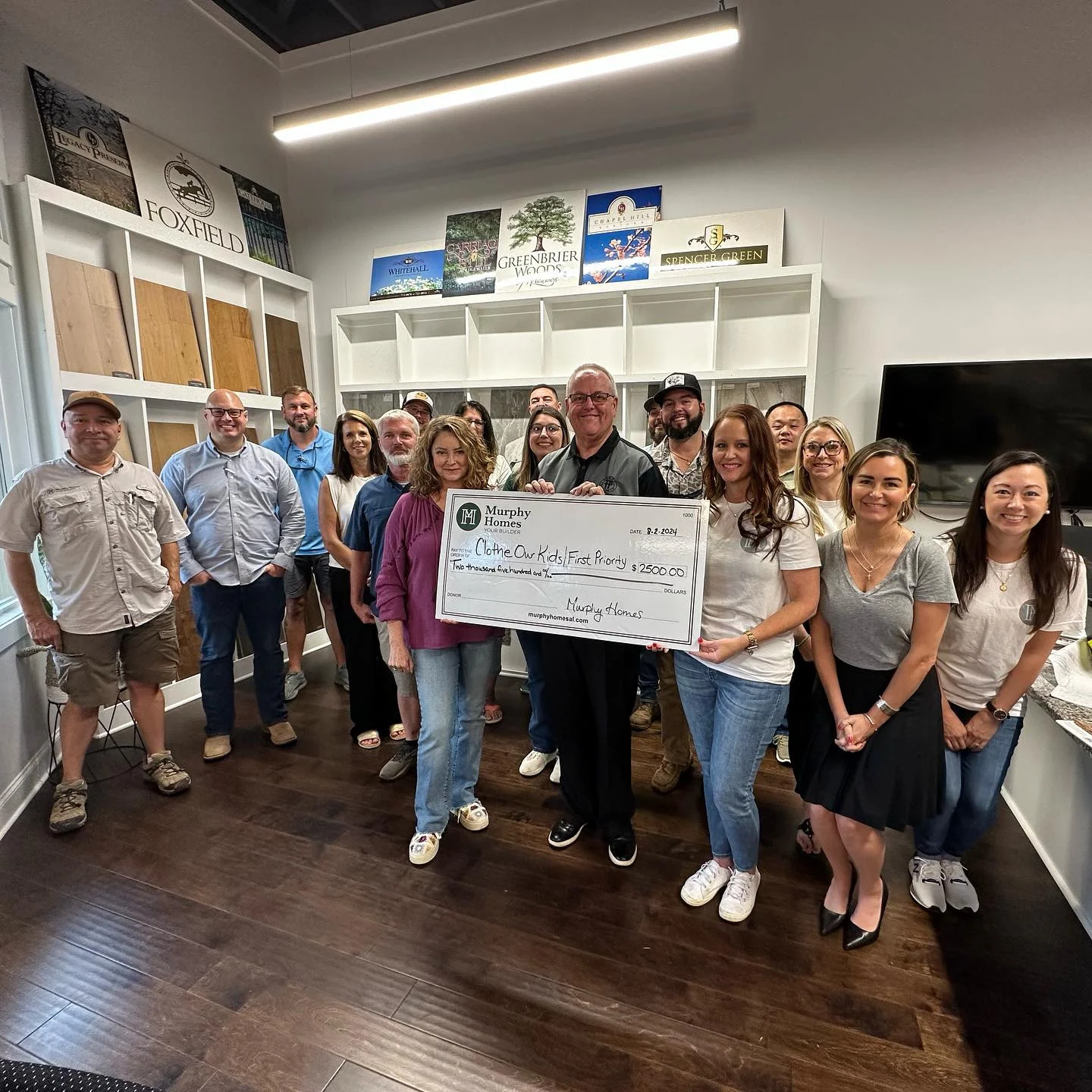 Presenting a donation check to a local charity at our monthly town hall meeting. 