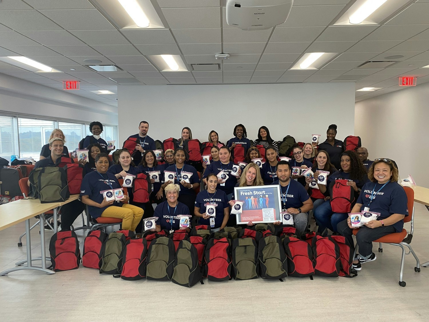 Team members posing at community backpack drive.