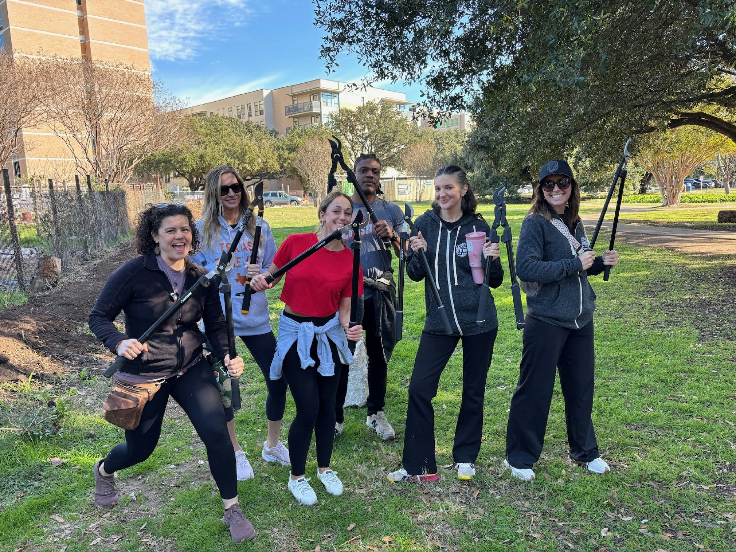 Team members rolling up their sleeves and giving back at a local community garden-growing together in more ways than one!