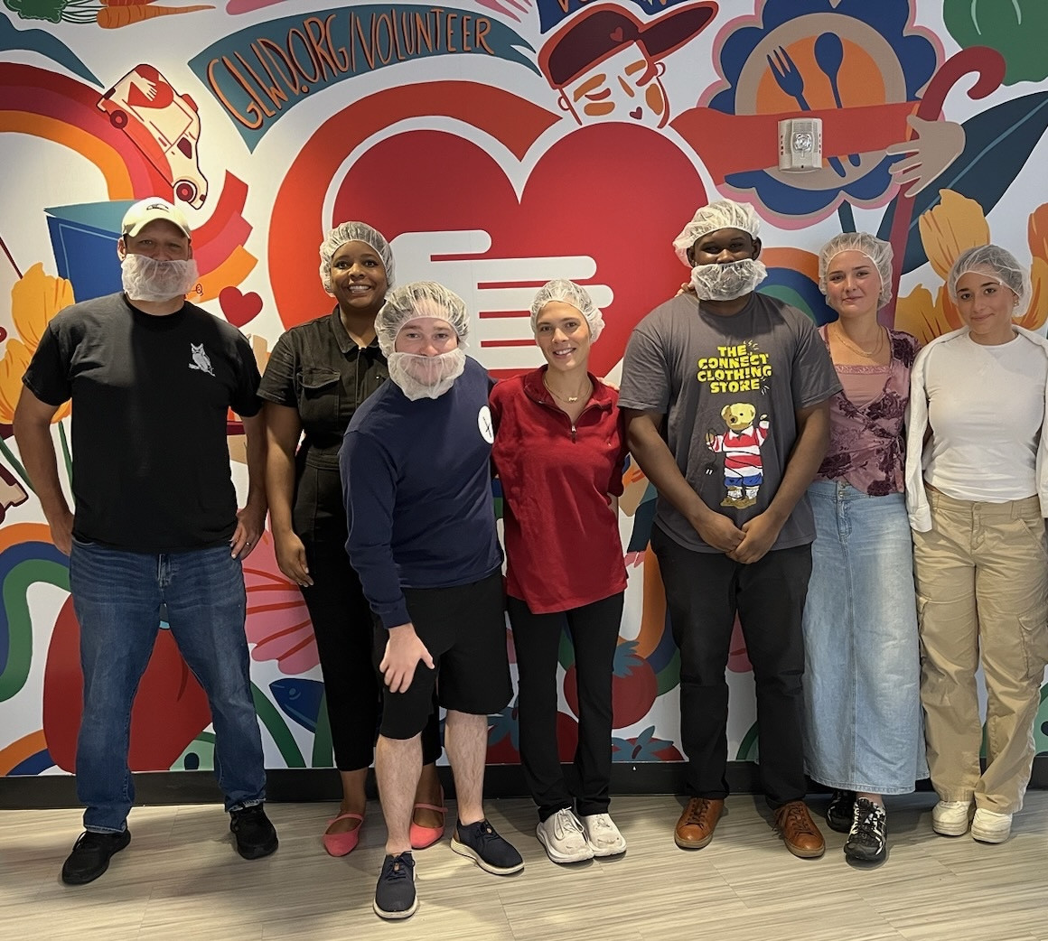 Giving back together—our team volunteering at a local food kitchen, supporting our community with time and compassion.