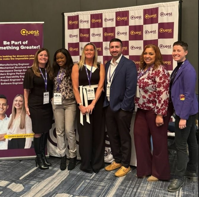 A group photo  of Questians at the Women in Engineering event shows a diverse and vibrant culture. 