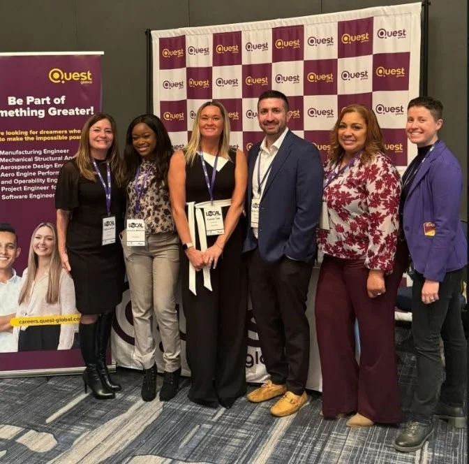 A group photo  of Questians at the Women in Engineering event shows a diverse and vibrant culture. 