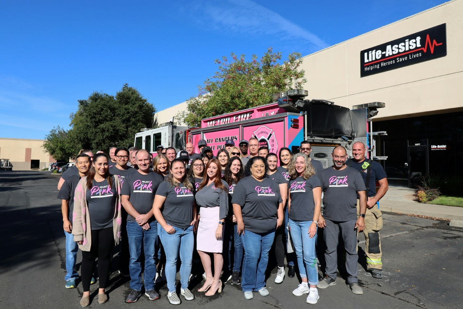 SacMetro Fire District visiting Life-Assist in their pink fire truck, in support of Breast Cancer Awareness Month