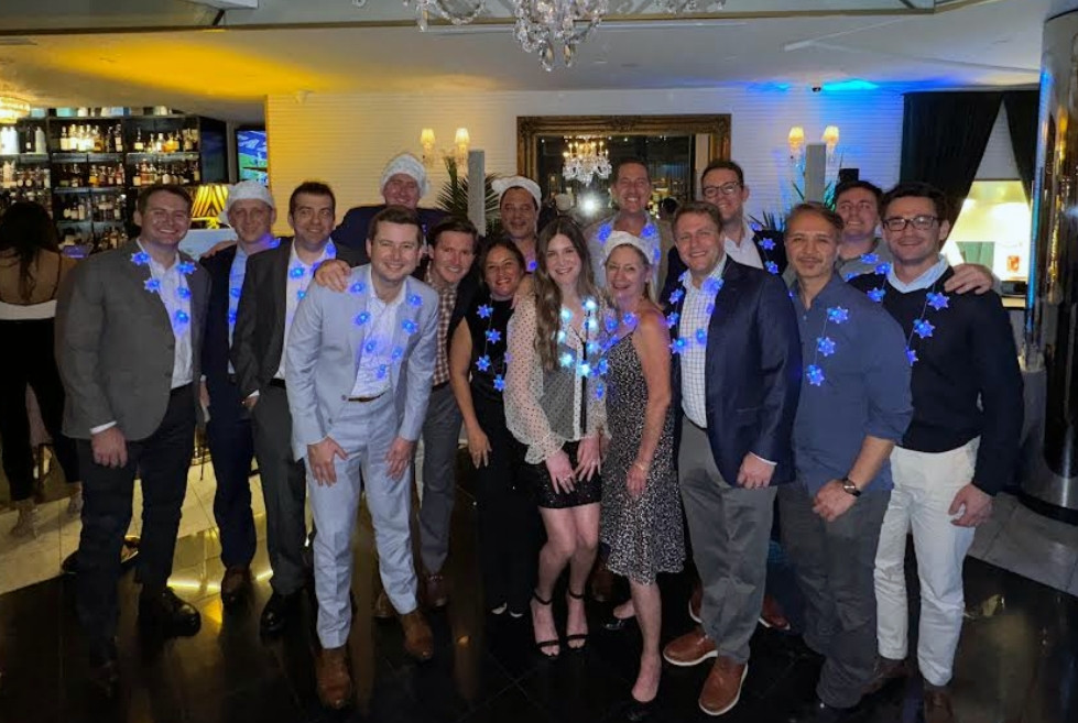 The team celebrated the holiday season with a dinner party complete with festive Santa hats and twinkling snowflakes.