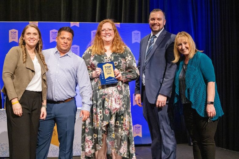 A group of employees at an awards event for Top Workplaces, local in our area. 
