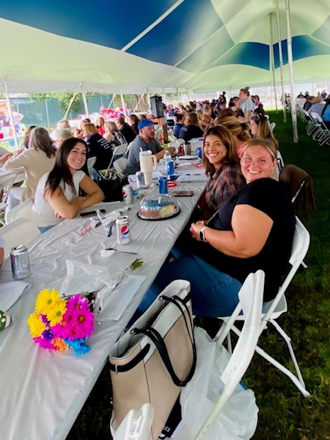 Staff enjoying the summer weather, good food, and employee recognition activities at the annual summer picnic.