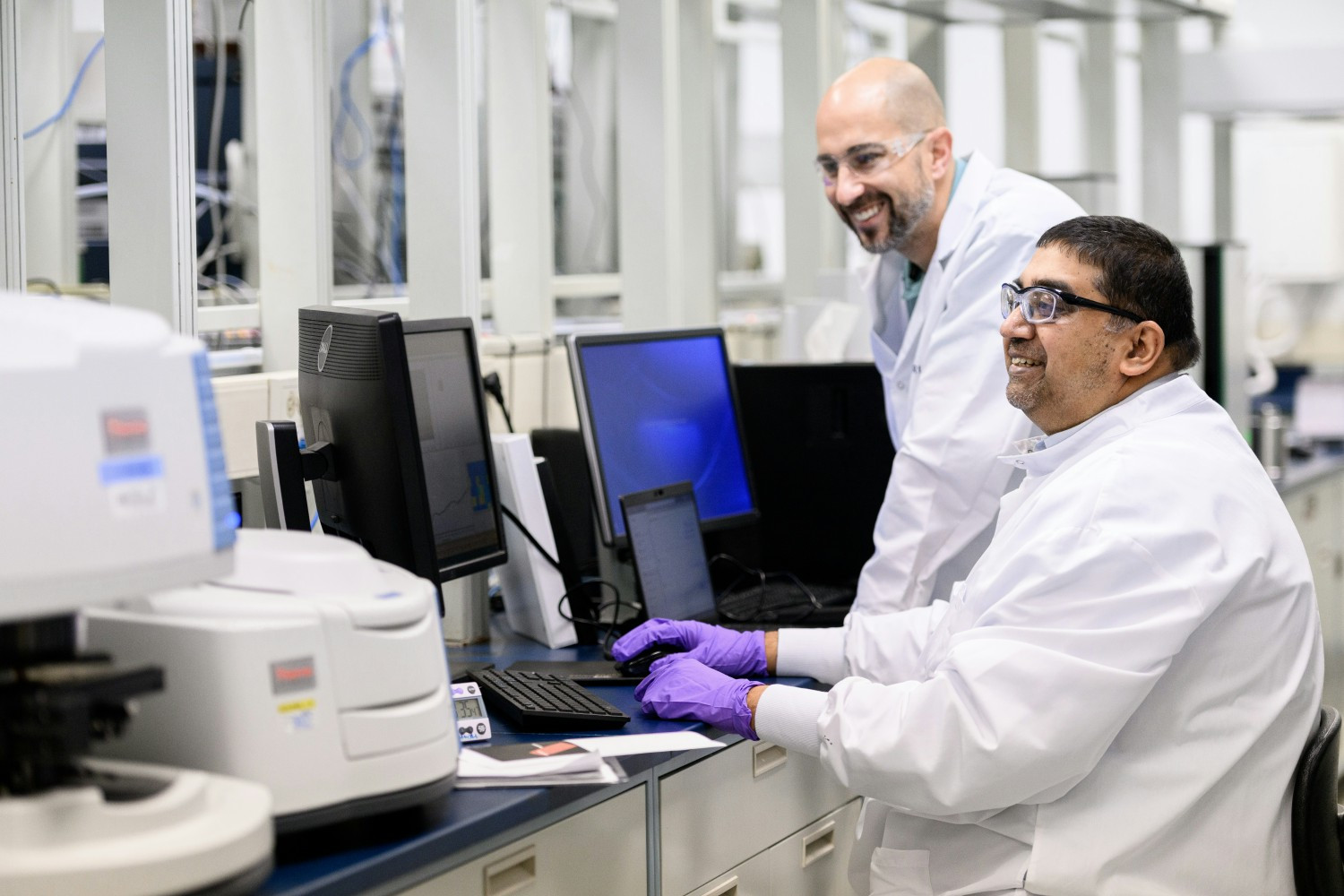 Advancing medicines for patients: Colleagues collaborating in a research & development lab.