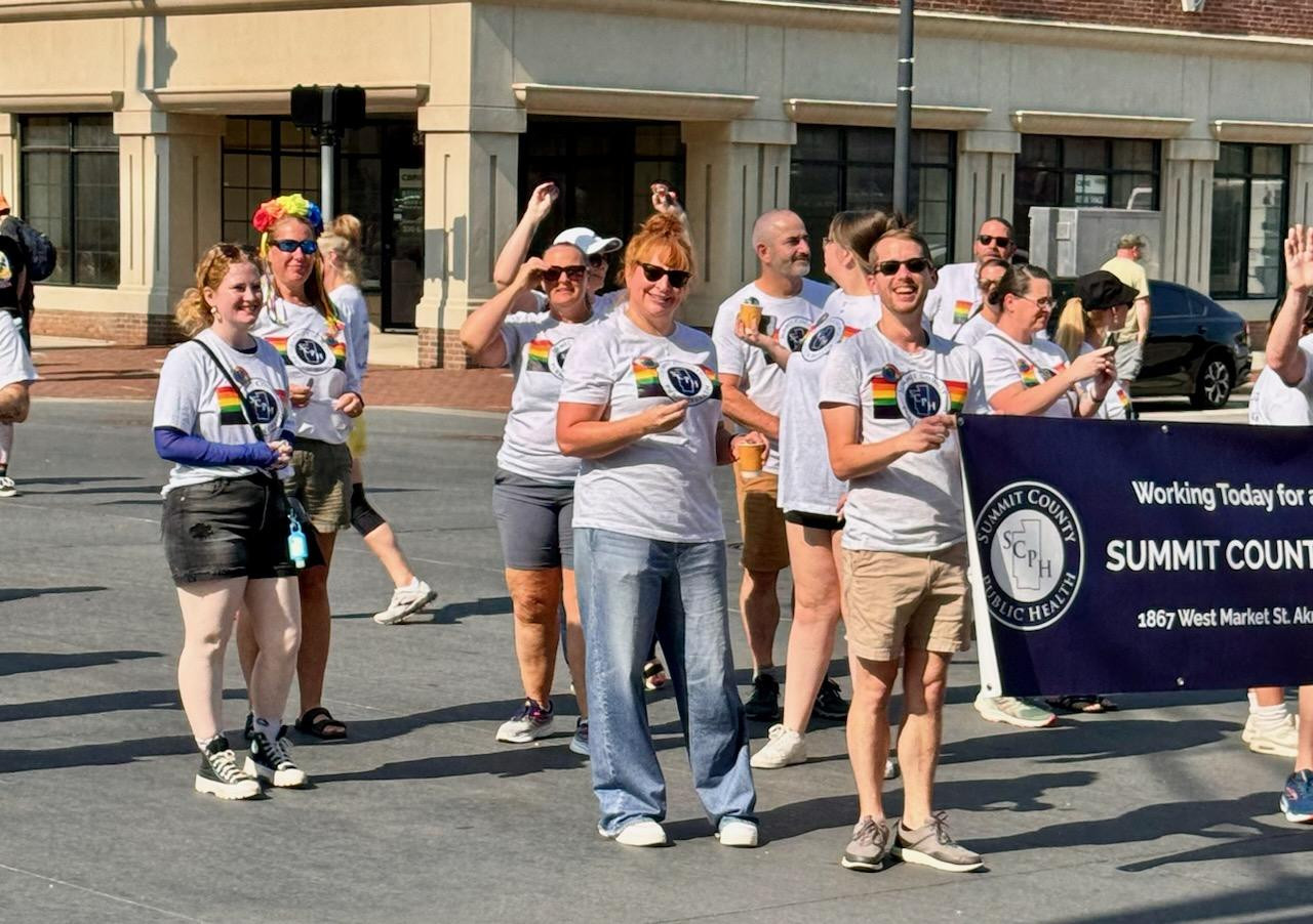 SCPH staff walking in a community parade to support Pride month.