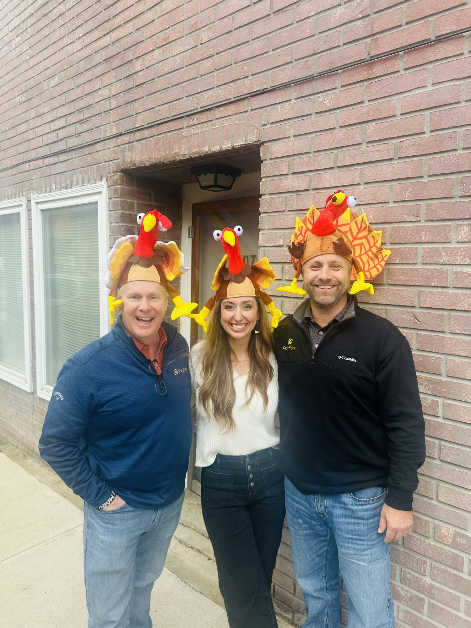 The Executive Team handing out turkeys to employees for Thanksgiving.