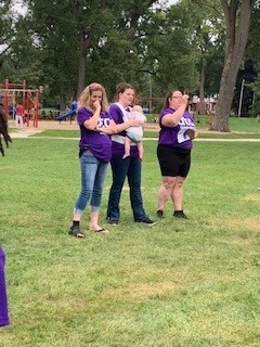 Watching cornhole tournament and scoring.