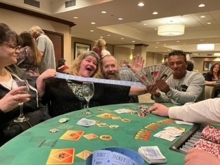 Christmas Casino night Brad, Dixie and Doeun show off their winnings.