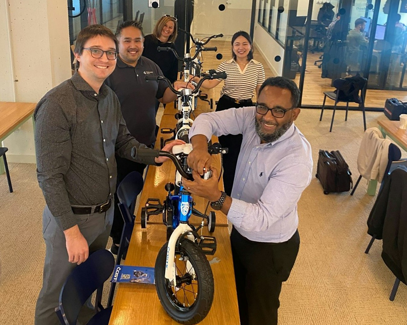 Our teams participating in giving back to the community by building bikes! 