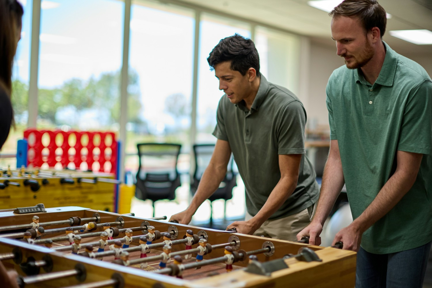 Quartus engineers Mario Blanco and Graham Martin taking a break to enjoy a game of foosball.