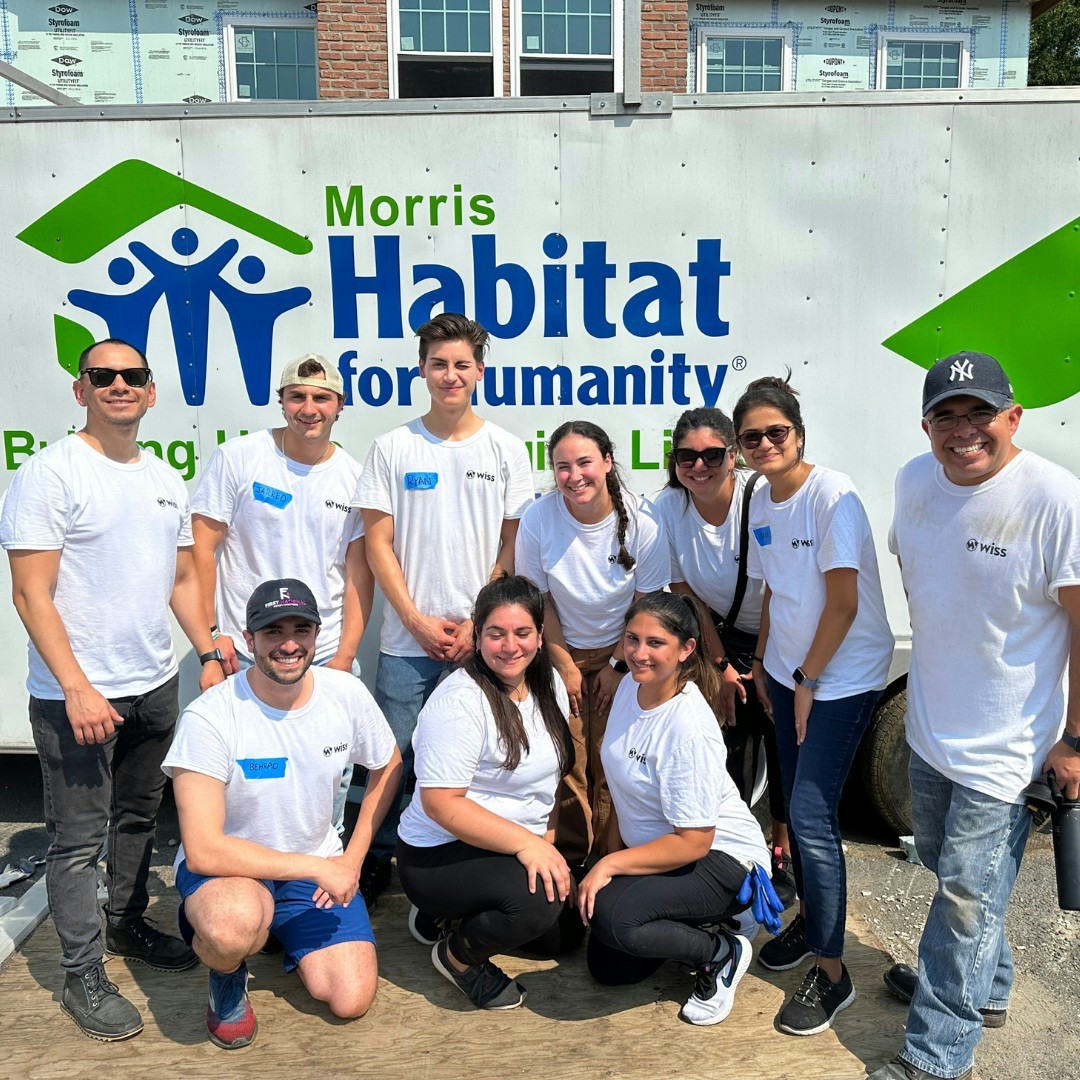 Team Wiss volunteers with Habitat for Humanity to build affordable housing for struggling families.