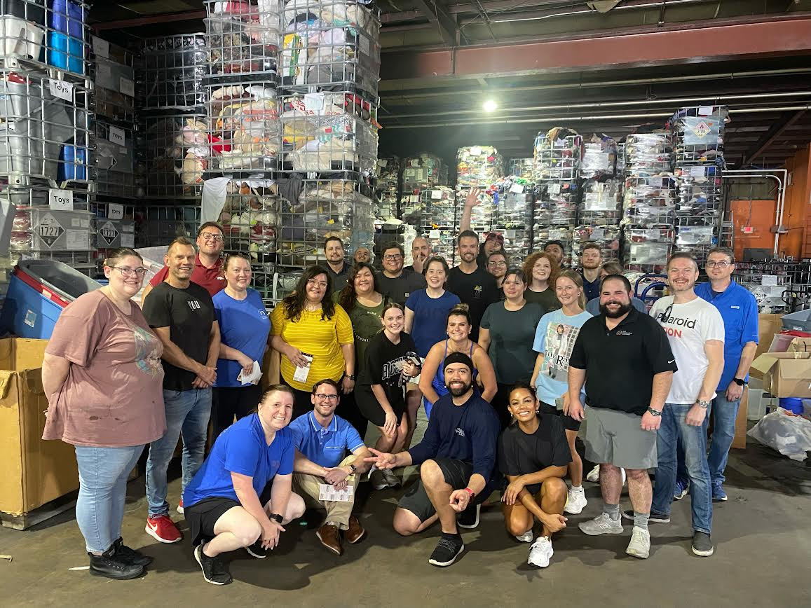 All of G&G volunteers with a local charity sorting items for their thrift store.